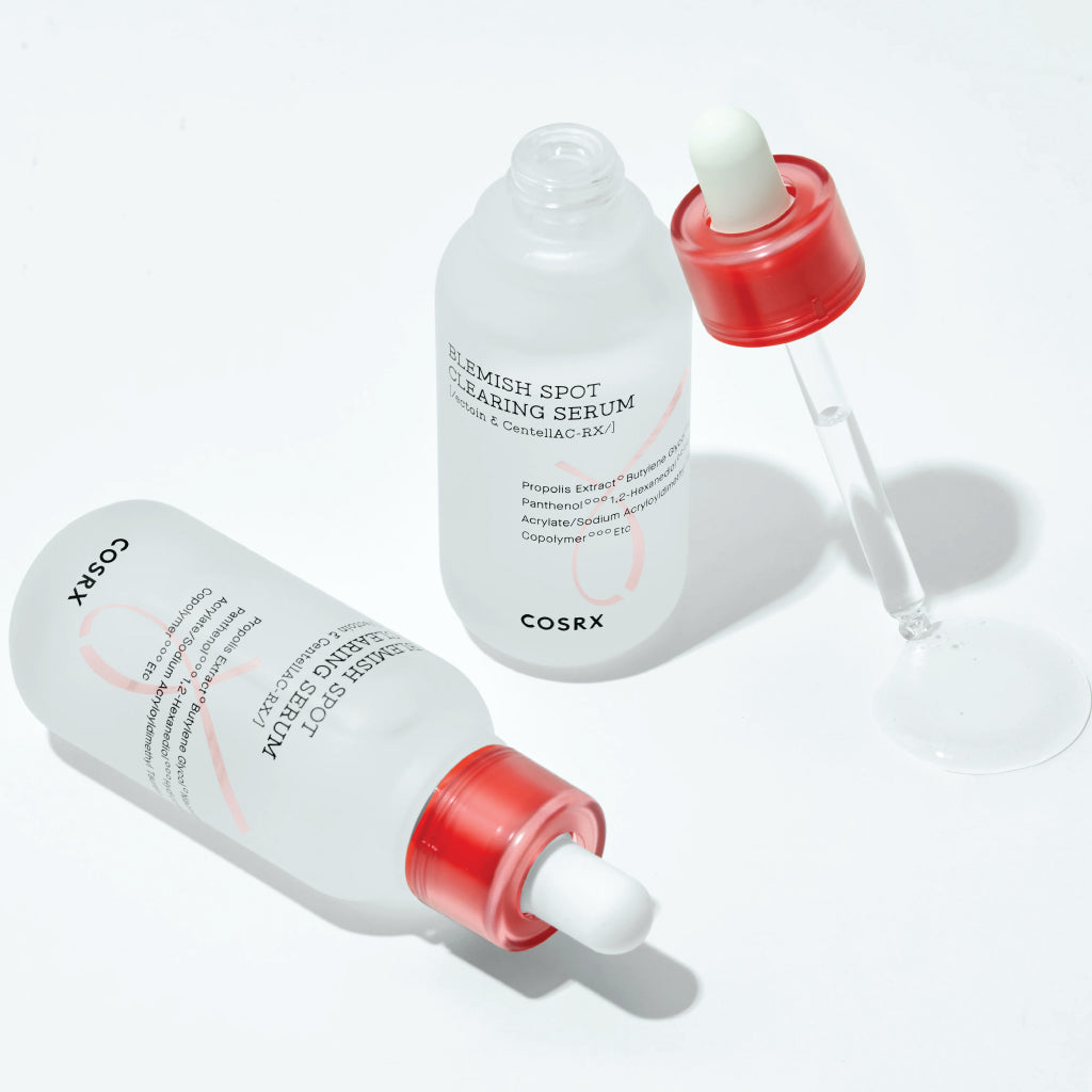 Two bottles of COSRX serum with droppers on a white background